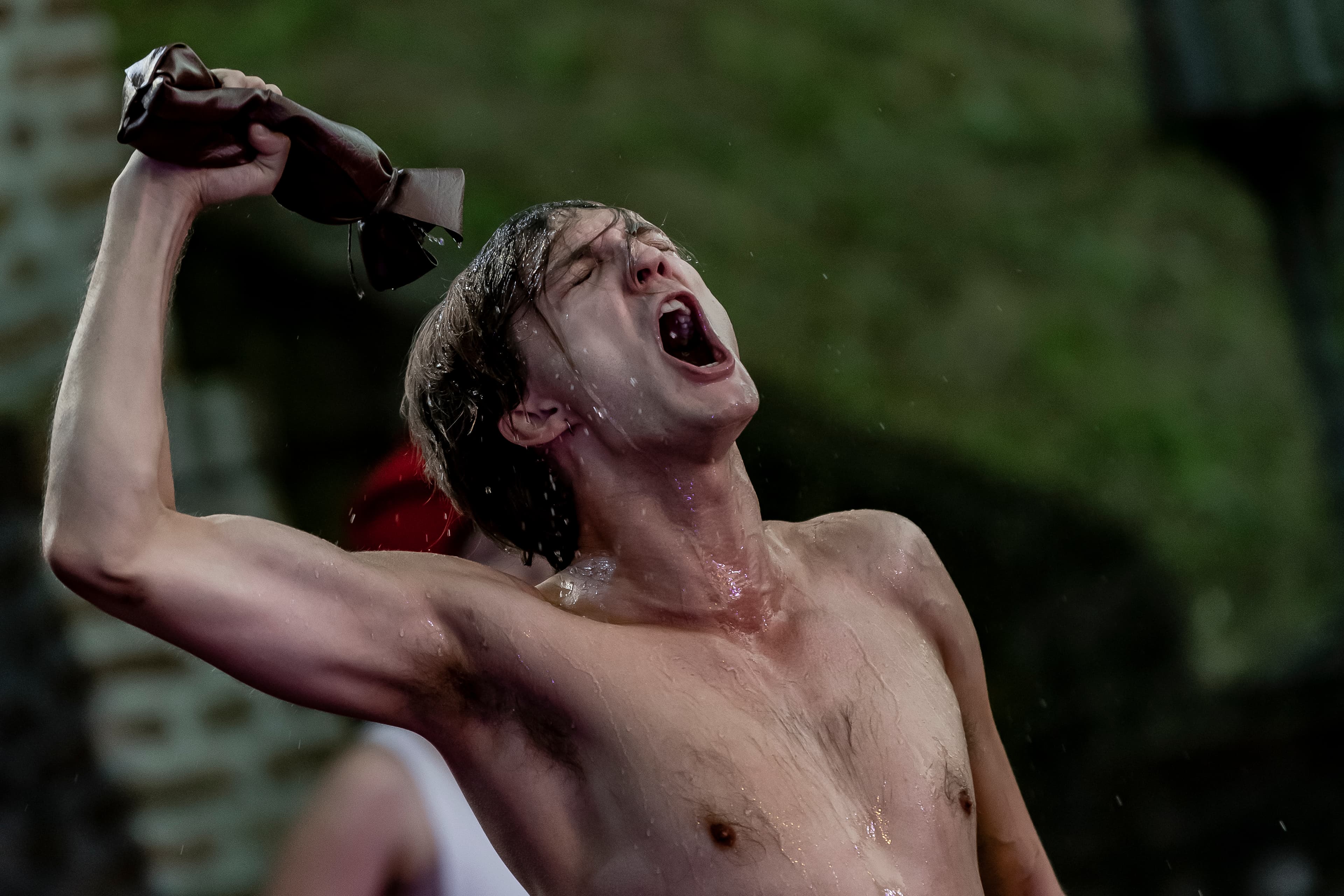 A powerful moment from Pericles on the main stage, showing a bare-chested actor drenched in water, raising a soaked cloth and shouting with raw emotion. This intense performance captures the physical and emotional depth of Flute Theatre’s sensory Shakespeare adaptations for autistic individuals.